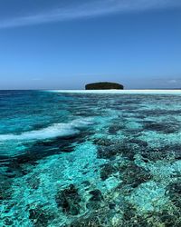 Scenic view of sea against sky at raja ampat island 