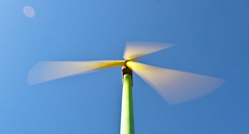 Low angle view of umbrella against blue sky