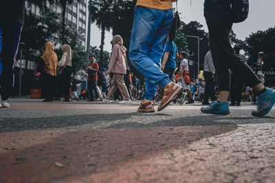 People walking on road in city