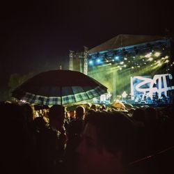 Group of people in front of building at night