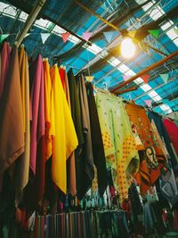 Low angle view of clothes hanging on ceiling at market
