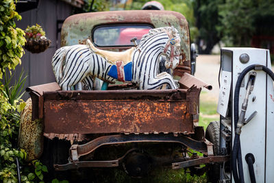 Rusted vehicle with old carnival horses