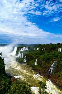 Scenic view of waterfall against sky