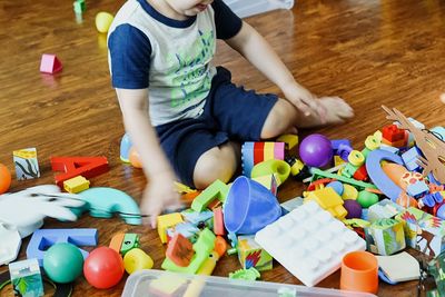 High angle view of boy playing with toy at home