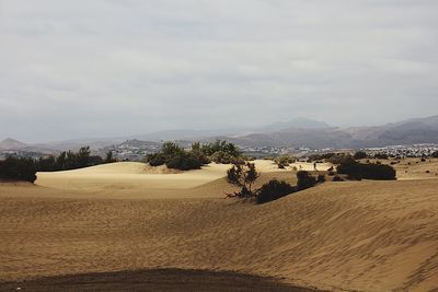 Scenic view of mountains against cloudy sky