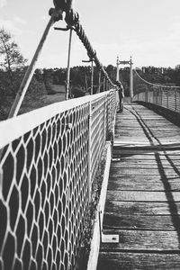 Footbridge over water against sky