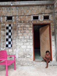 Portrait of man standing against building