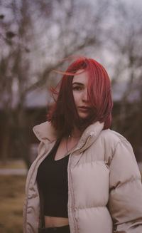 Portrait of young woman standing outdoors