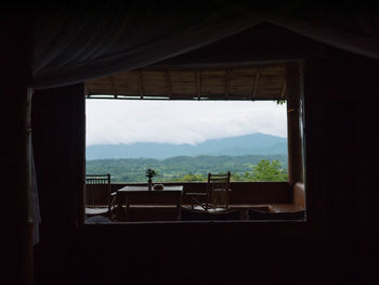 Scenic view of mountains seen through window