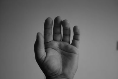 Close-up of hand over white background