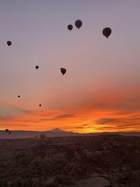 Hot air balloons flying in sky during sunset