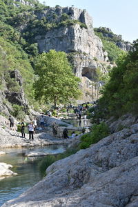 People on rock against trees