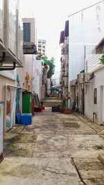 Alley amidst buildings in city against sky