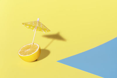 Close-up of drink against yellow background