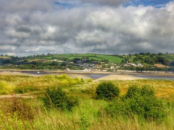 Scenic view of landscape against cloudy sky