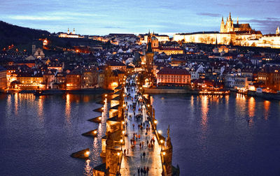 Illuminated buildings in city at dusk