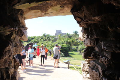 Rear view of people walking on historical building