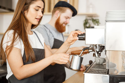 Young couple holding coffee