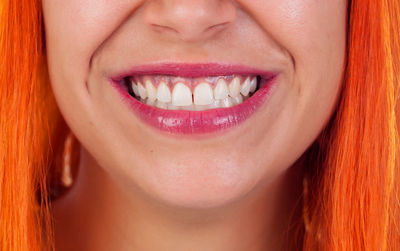 Close-up of smiling woman with dyed hair