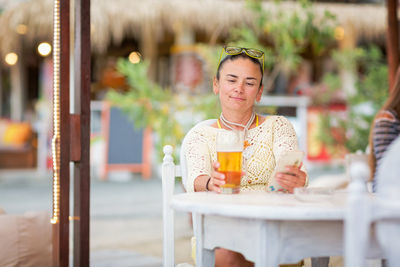 Portrait of smiling young woman sitting in cafe