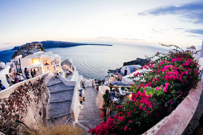 Fish-eye lens view of buildings by aegean sea against sky