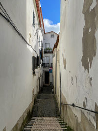 Empty alley amidst buildings in city