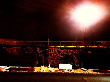 Illuminated candles against sky at night