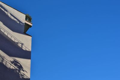 Low angle view of built structure against clear blue sky