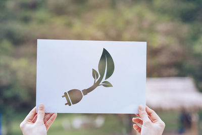 Midsection of woman holding paper