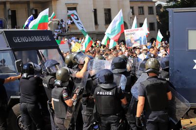 Police force controlling protestors on street