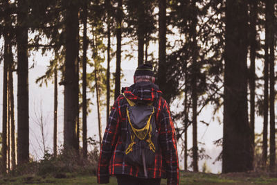 Man walking against trees in forest