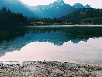 Scenic view of lake and mountains against sky