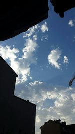 Low angle view of building against cloudy sky