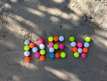 High angle view of multi colored stones on sand