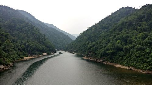 Scenic view of river amidst mountains against clear sky