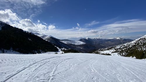 Scenic view of snow covered mountains against sky