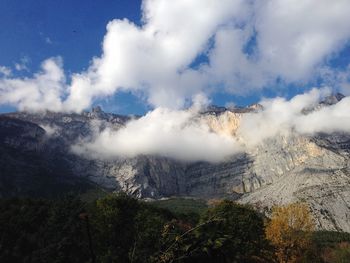 Scenic view of mountains against cloudy sky