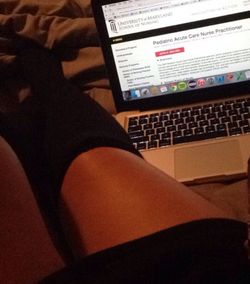 Full length of woman relaxing on bed