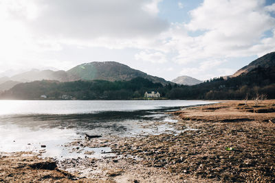 Scenic view of lake and mountains against sky