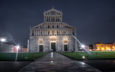 Empty footpath leading towards pisa cathedral at night