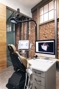 Dentist's chair and monitors in clinic