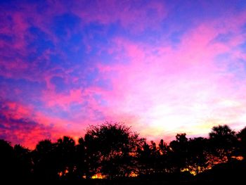 Silhouette trees against sky during sunset