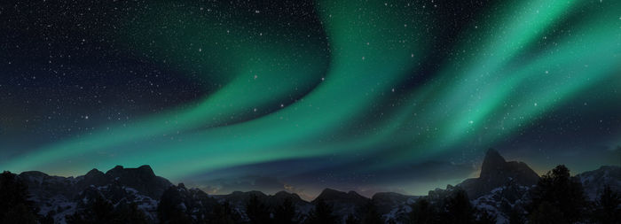 Scenic view of snowcapped mountains against sky at night