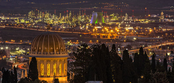 Aerial view of city lit up at night