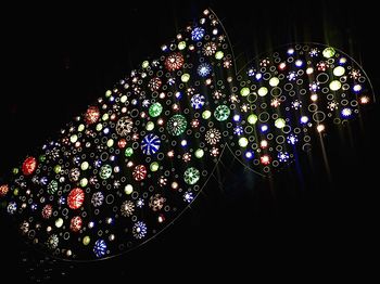 Low angle view of illuminated christmas tree at night