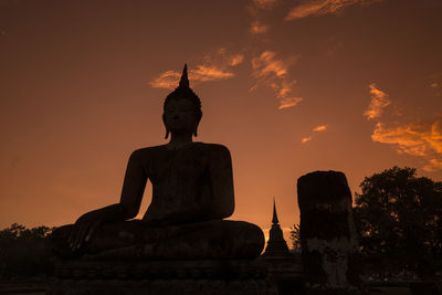 Statue against sky during sunset