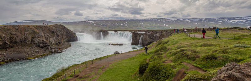 Thundering massive godafoss waterfall during a brief icelandic summer