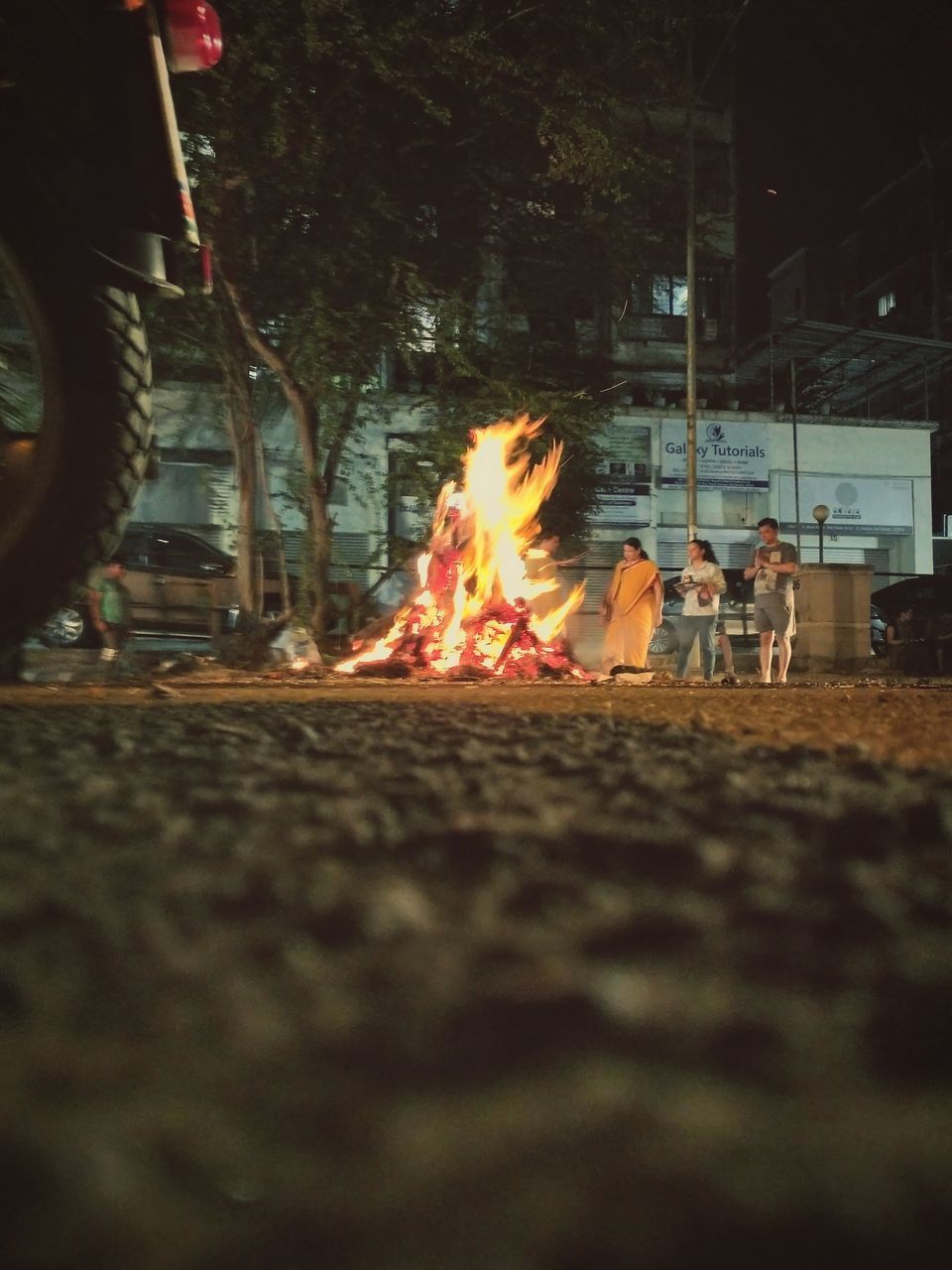 BONFIRE ON STREET AT NIGHT