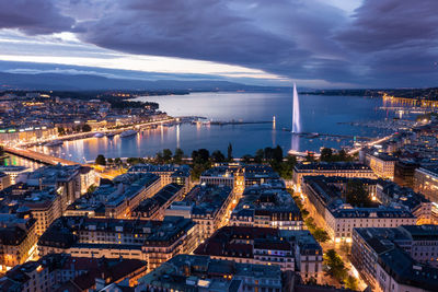 High angle view of illuminated city buildings at dusk