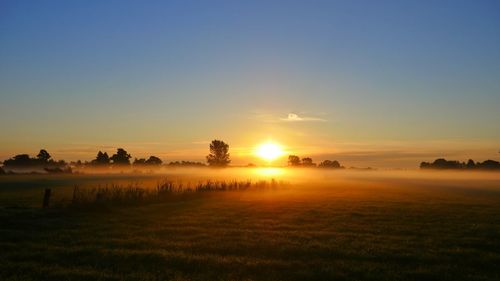 Scenic view of sunset over land